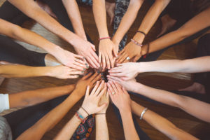 Diverse hands in a yoga circle